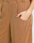 Beach Rose Co. camel linen-blend barrel-leg pants featuring oversized curved front pockets and a flat waistband.