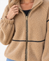Beach Rose Co. camel sherpa jacket with black contrast trim, gold zip-front, and stand collar on a model.