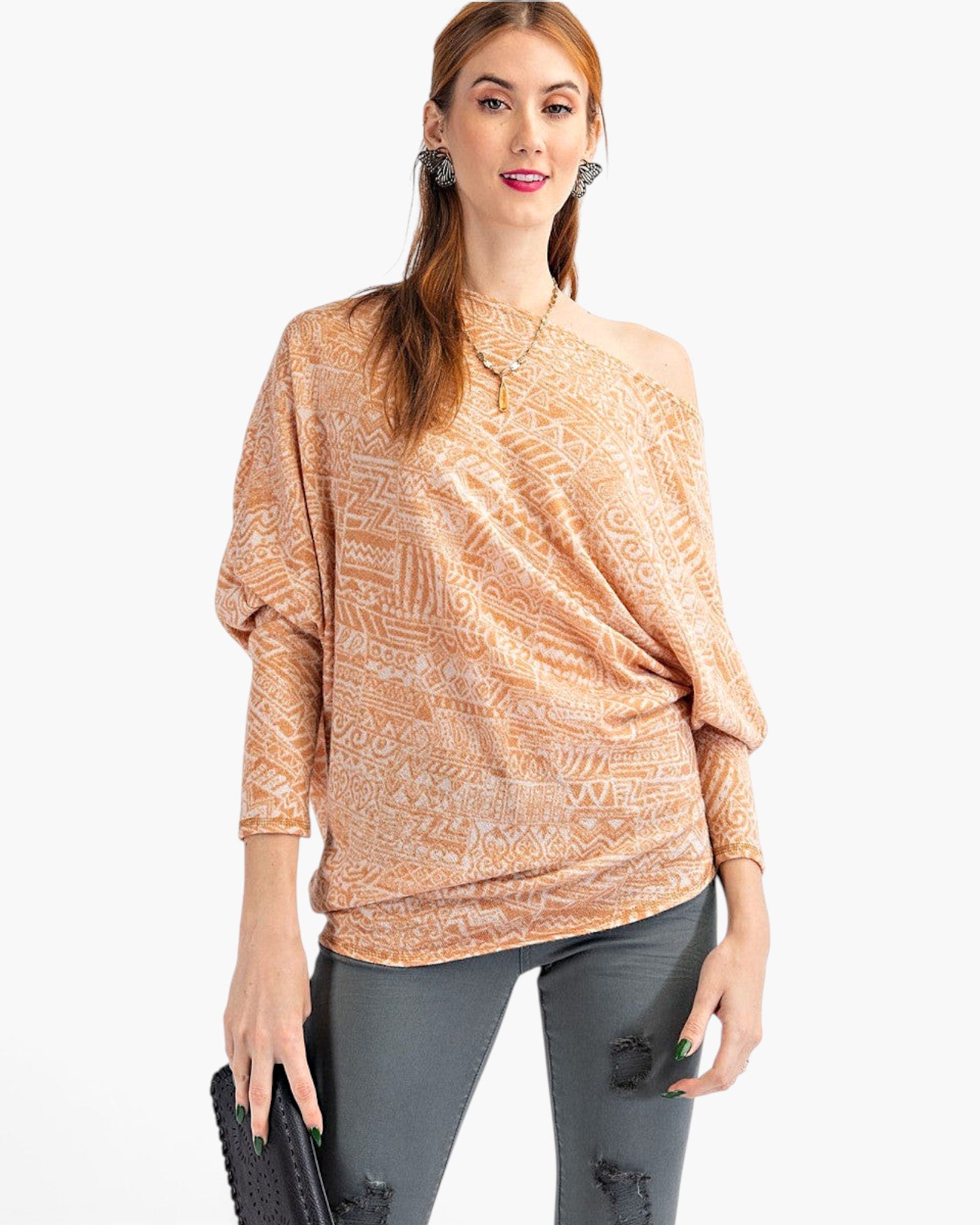Beach Rose Co. camel knit top with tribal print, asymmetrical neckline, and dolman sleeves worn by a model.