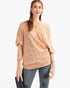 Beach Rose Co. camel knit top with tribal print, asymmetrical neckline, and dolman sleeves worn by a model.