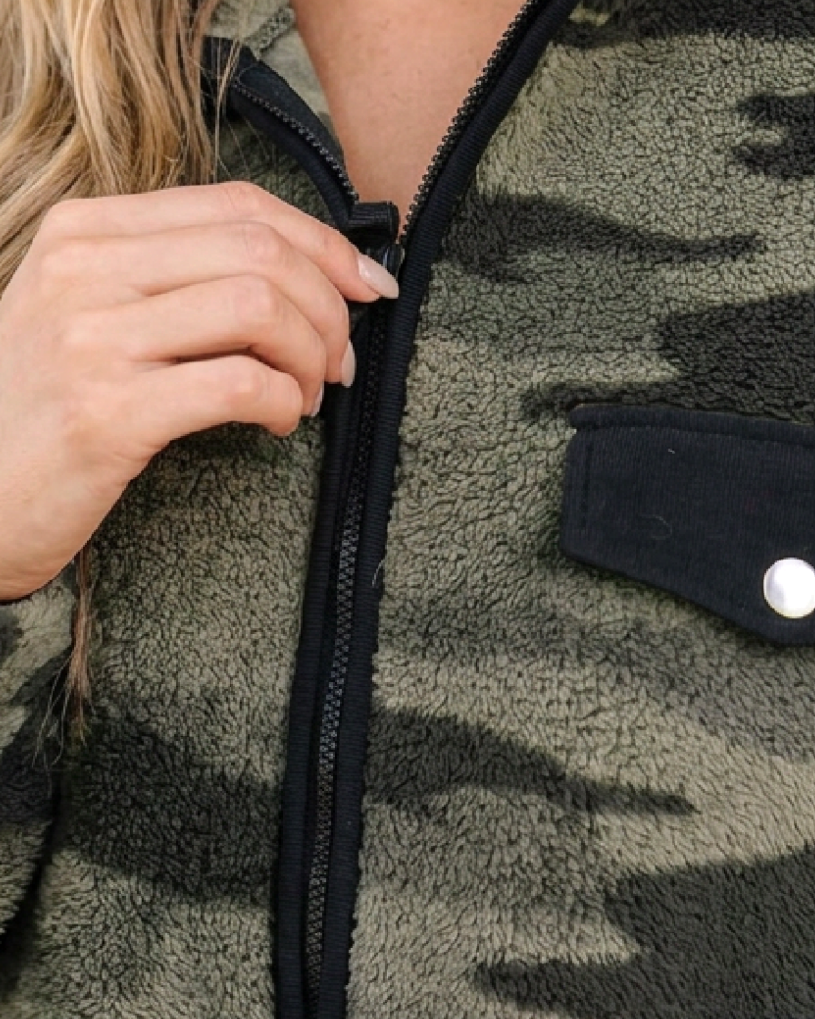 Beach Rose Co. camo fleece sweatshirt with a half-zip closure and black patch pocket detail.