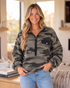 Beach Rose Co. camo print fleece sweatshirt with half-zip, front patch pocket, and relaxed fit on a smiling woman.