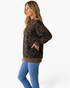 Beach Rose Co. women wearing a relaxed camo sweatshirt with a ribbed mock neck and brown hem, side view.