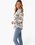 Beach Rose Co. sage and gray camo waffle knit long sleeve top with a relaxed fit and curved hem worn by a model.