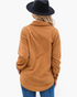 Beach Rose Co. caramel textured shacket with a collared neckline and curved hem worn by a woman in a black hat