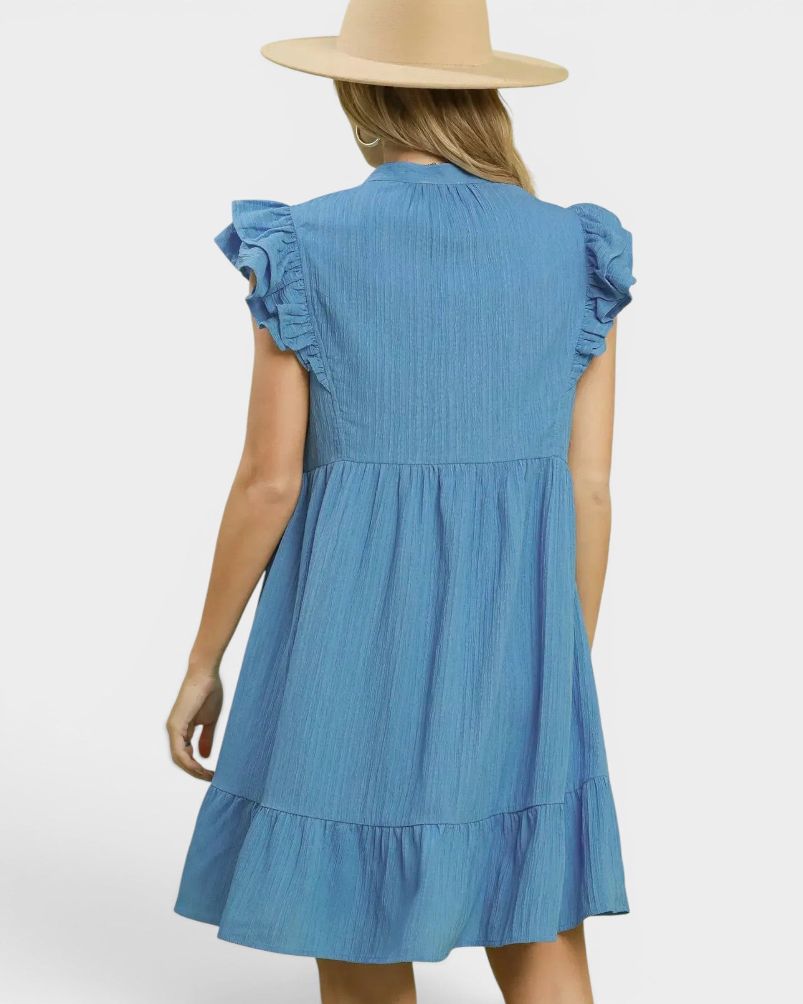 Beach Rose Co. Chambray blue mini dress with ruffle sleeves, split neckline, tiered silhouette, and side pockets. 100% polyester.
