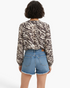Back view of Beach Rose Co. charcoal and cream viscose blend blouse with mixed animal print and long raglan sleeves.