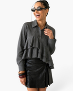 Beach Rose Co. charcoal pinstripe blouse with cascading front ruffles, collared neckline, and long sleeves on a model.