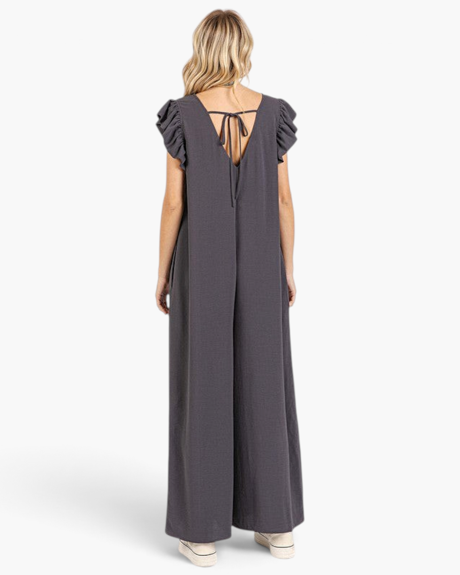 Beach Rose Co. charcoal wide-leg jumpsuit with layered ruffle sleeves, V-back, and adjustable tie-back detail.