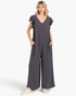 Beach Rose Co. charcoal wide-leg jumpsuit with layered ruffle sleeves, V-neckline, and side pockets on a model.