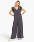 Beach Rose Co. charcoal wide-leg jumpsuit with layered ruffle sleeves, V-neckline, and relaxed fit on a model.