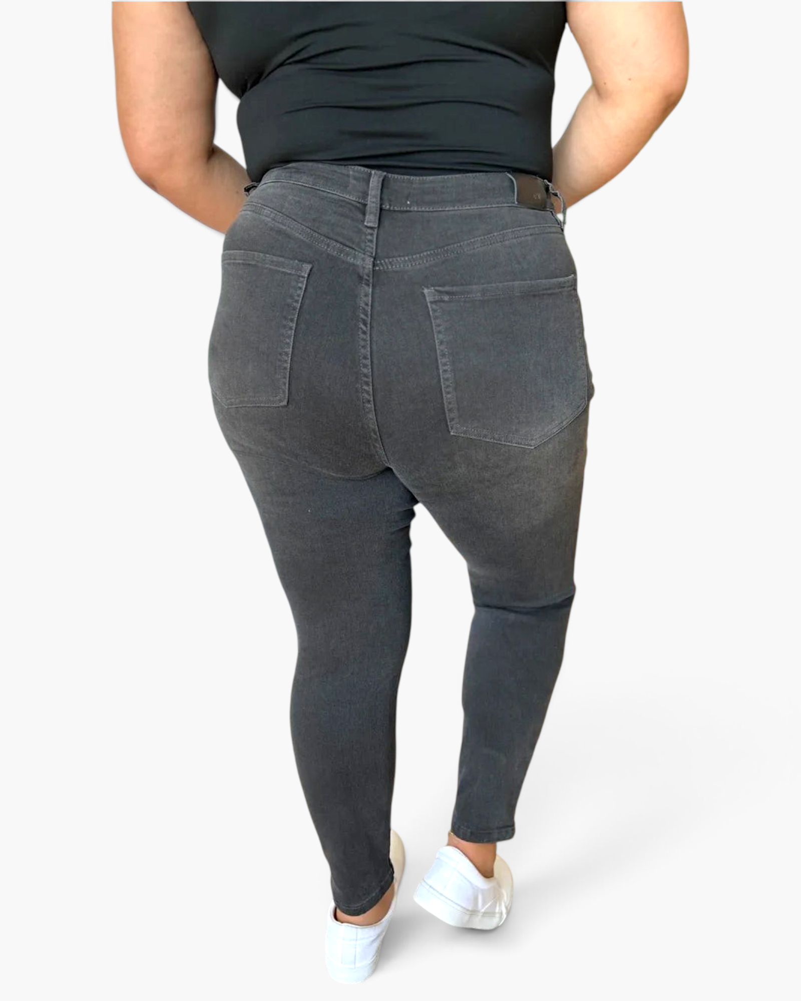 Beach Rose Co. high rise tummy control skinny jeans in charcoal grey with back pockets, worn by a model.