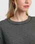 Beach Rose Co. charcoal grey stretch modal basic top with a crew neckline worn by a woman with gold hoop earrings.