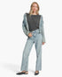 Beach Rose Co. model wearing a charcoal stretch modal basic top layered under a light wash denim jacket and jeans.