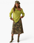 Beach Rose Co. chartreuse ribbed knit sweater with asymmetrical zip, worn by a model with a patterned beret and skirt.