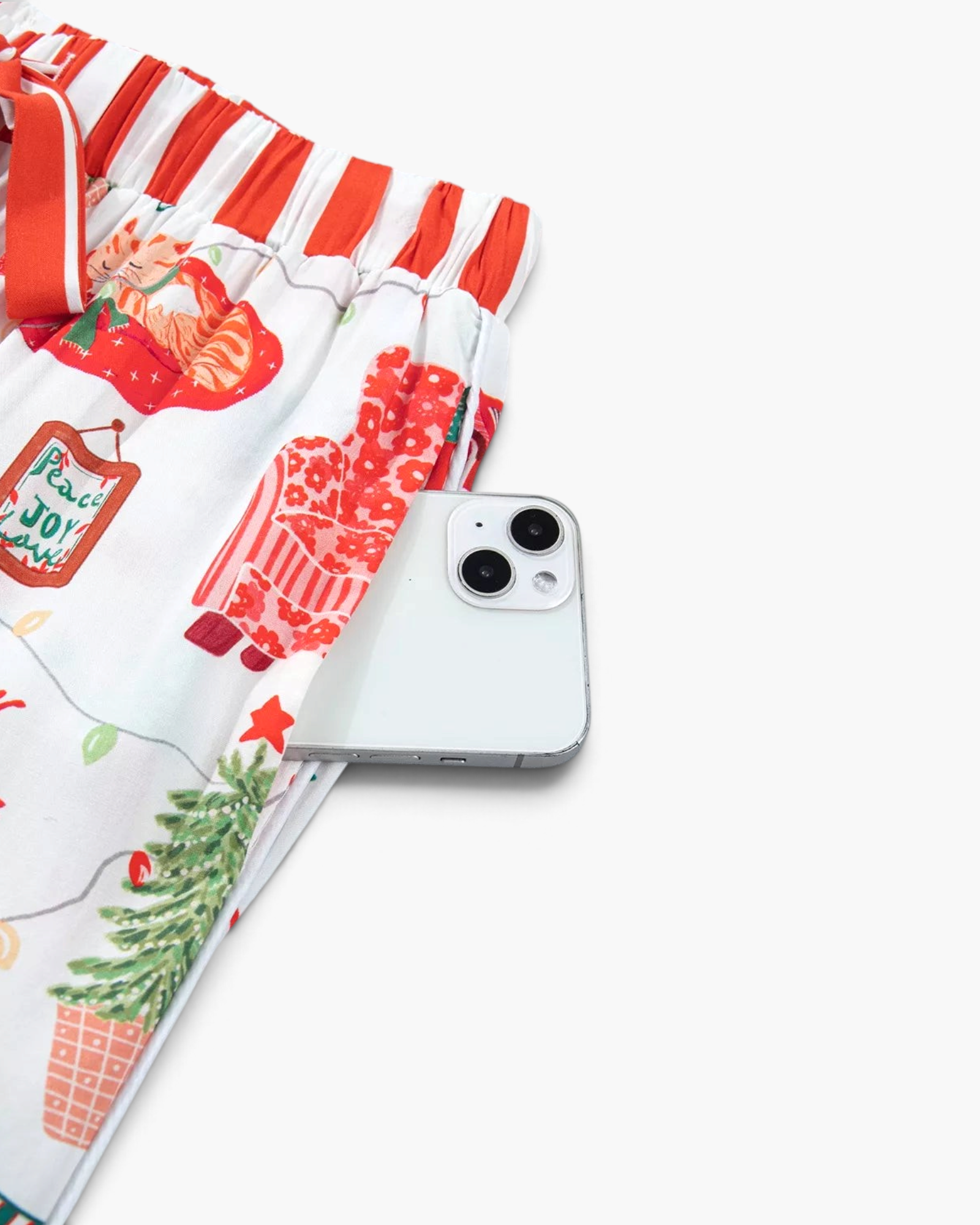 Beach Rose Co. white viscose pajama pants with festive Christmas print and red striped waistband and side pocket