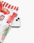 Beach Rose Co. white viscose pajama pants with festive Christmas print and red striped waistband and side pocket