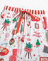 Beach Rose Co. white pajama pants with festive Christmas print, red and white striped waistband, and drawstring tie.