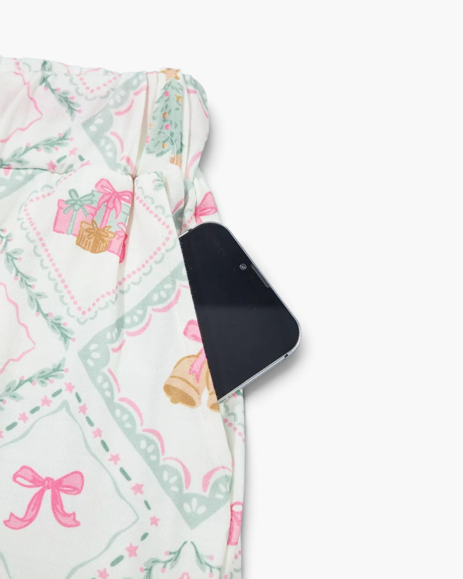 Beach Rose Co. pajama pants in cream with pastel Christmas diamond print and a functional side pocket holding a phone
