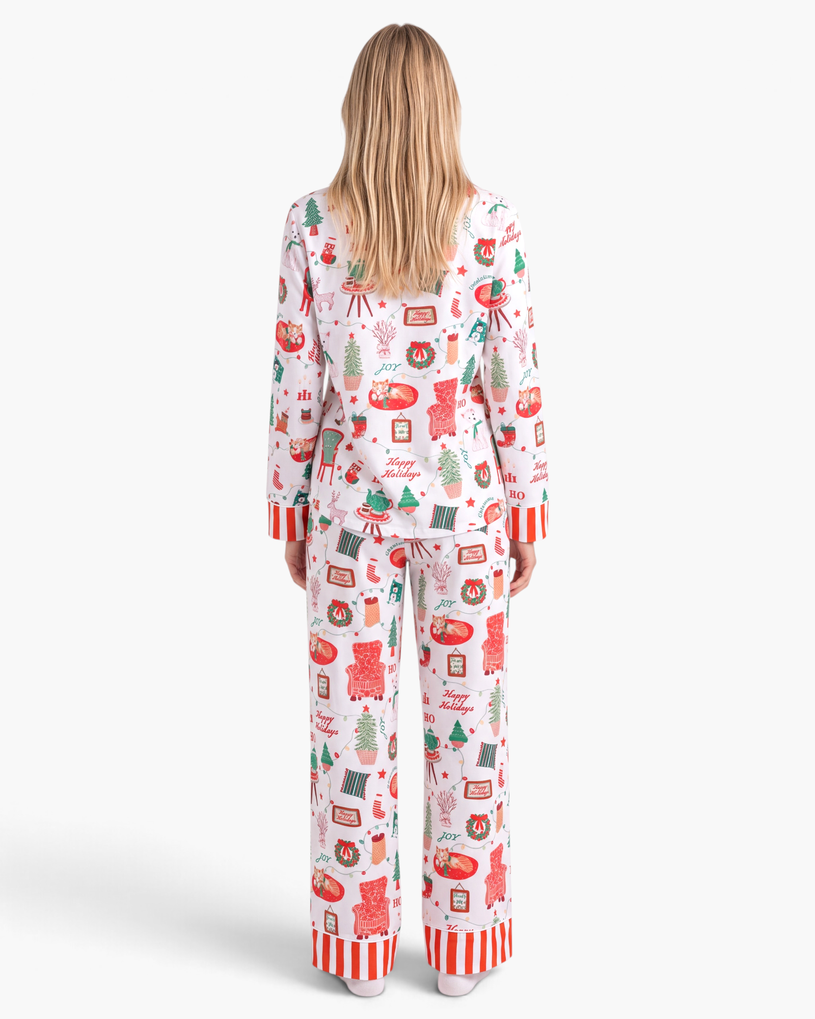 Beach Rose Co. white Christmas print pajama set with red and green festive motifs and striped trim, back view.