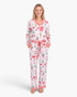 Beach Rose Co. white viscose pajama set with festive Christmas print, red striped trim, and button-front top.