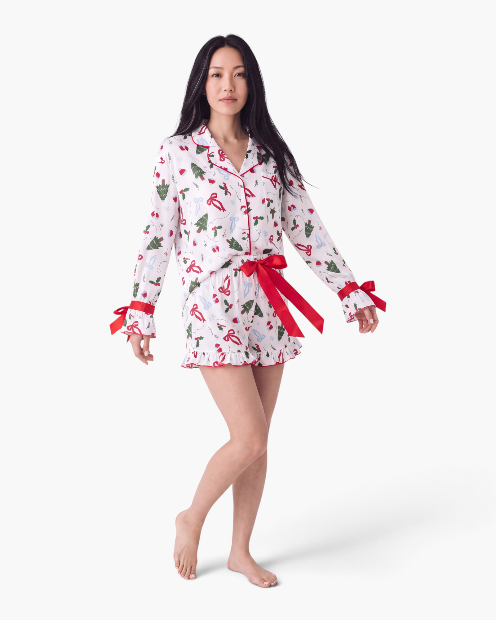 Beach Rose Co. white viscose pajama set with Christmas print, red bow accents, and ruffled shorts hem.