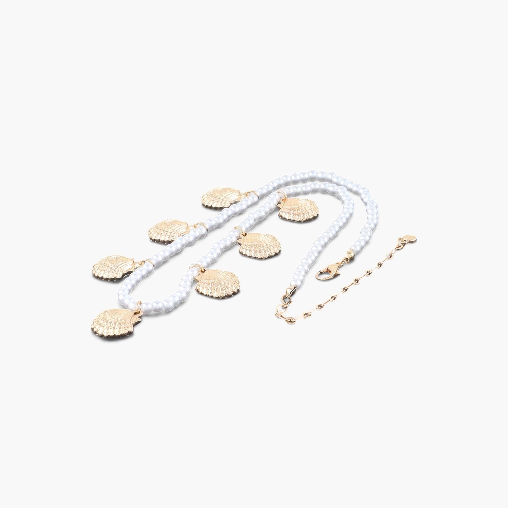 Beach Rose Co. gold and pearl necklace featuring multiple clamshell charms on a white pearl beaded chain