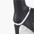 Beach Rose Co. tennis bracelet featuring a row of clear square-cut cubic gemstones on a black display stand