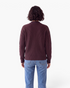 Back view of a Beach Rose Co. coffee brown knit cardigan with ribbed trim and long sleeves worn with blue jeans.