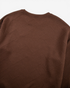 Beach Rose Co. coffee brown crew neck sweatshirt with an allover geometric textured pattern and ribbed collar.