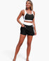Beach Rose Co. two-piece color block bikini with a black and white athletic top and high-waisted skirted bottoms.