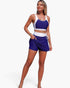 Beach Rose Co. two-piece color block bikini with a navy and white high-waisted skirted bottom and matching crop top.
