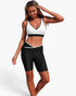 Beach Rose Co. two-piece color block yoga set with white sleeveless sports bra and black high-waisted biker shorts