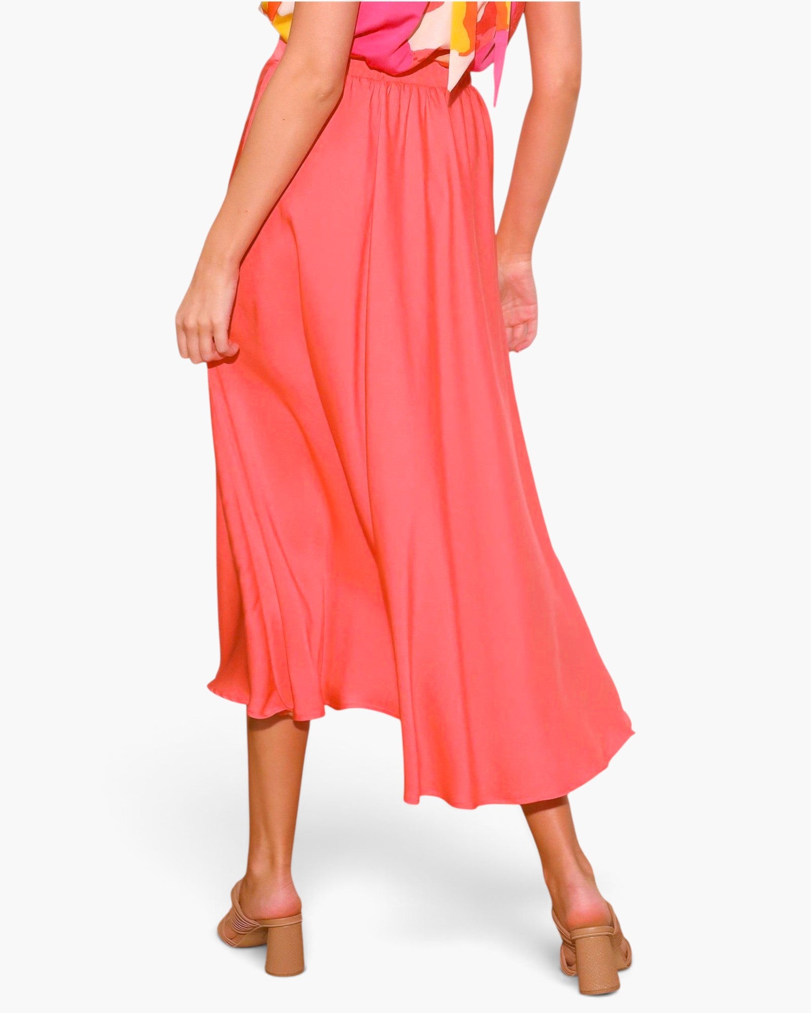 Beach Rose Co. coral pink washed poly silk midi swing skirt with pleated detail worn with tan block heel sandals