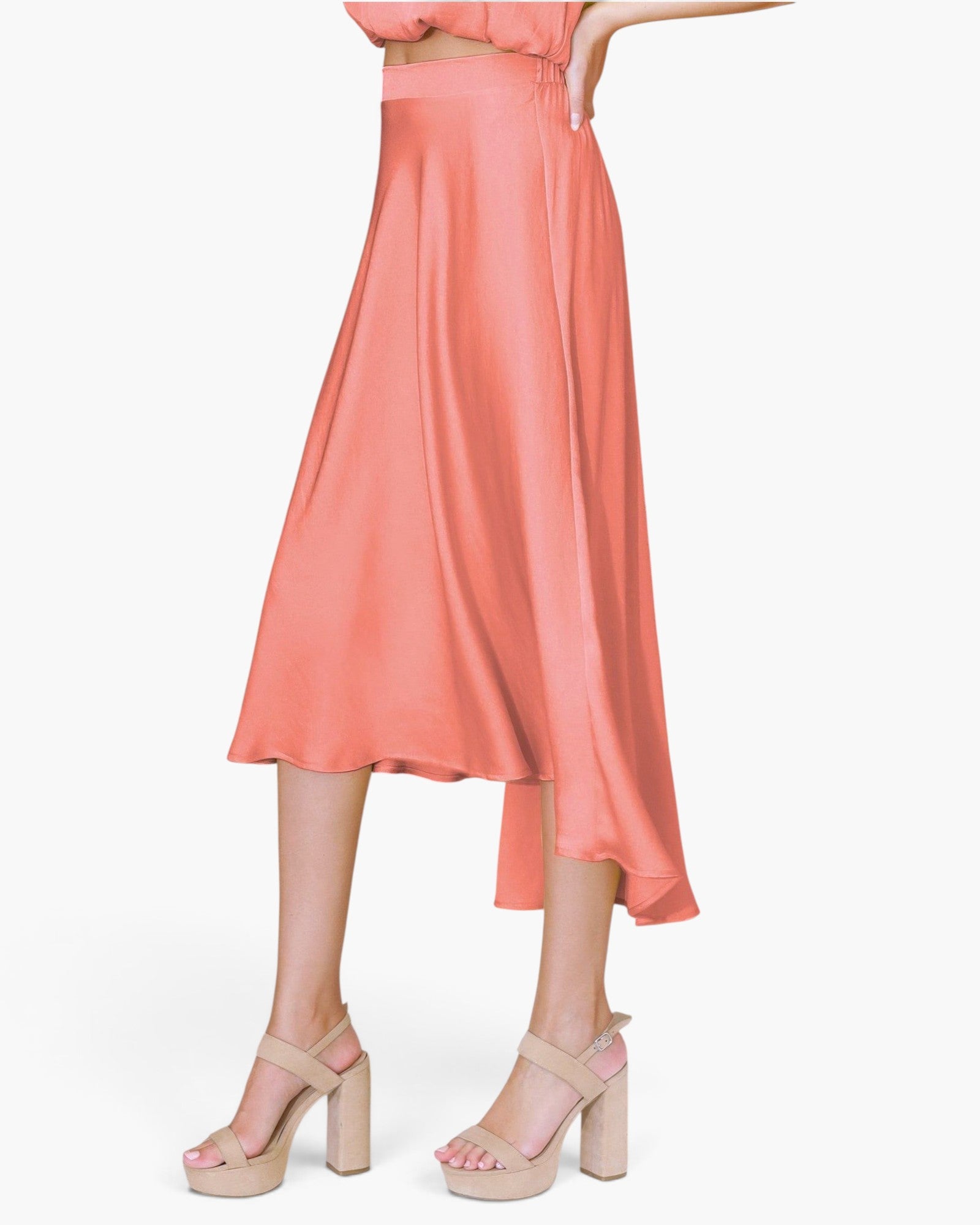 Beach Rose Co. coral washed poly silk midi swing skirt with a fluid drape and high-low hemline on a model.
