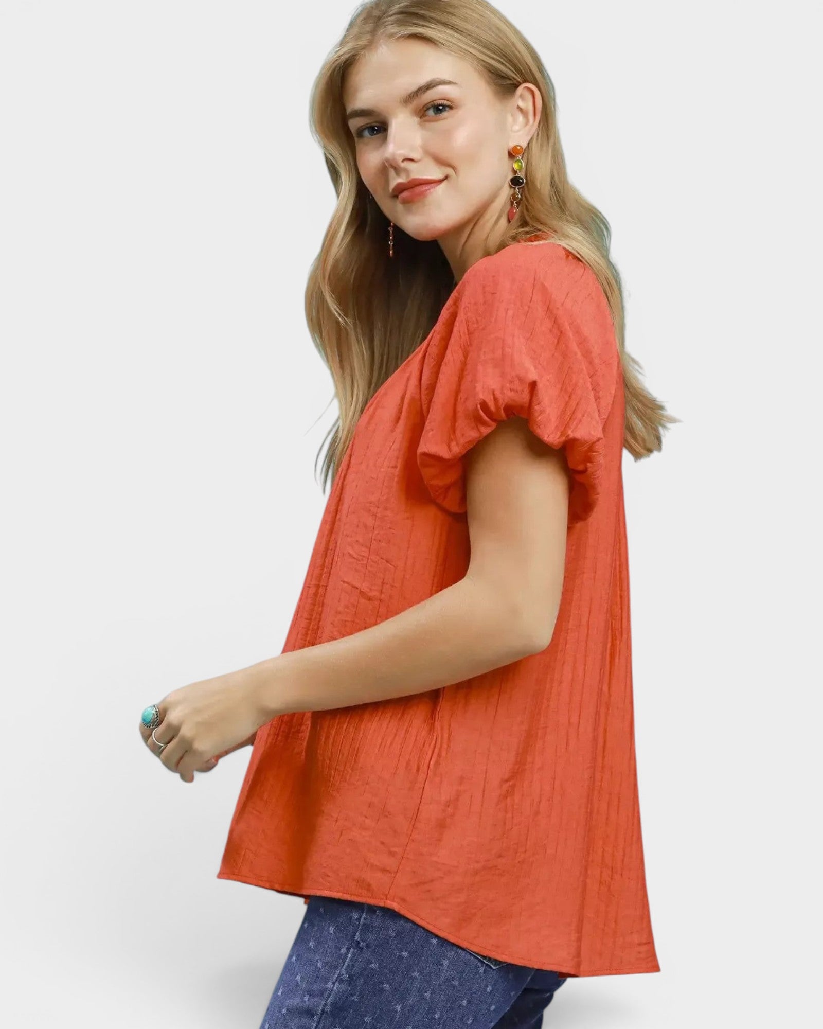 Beach Rose Co. coral orange puff sleeve blouse with gathered V-neckline and textured fabric.