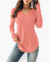 Beach Rose Co. coral pink long sleeve top in a vertical ribbed knit with a wide V-neckline and curved hem.