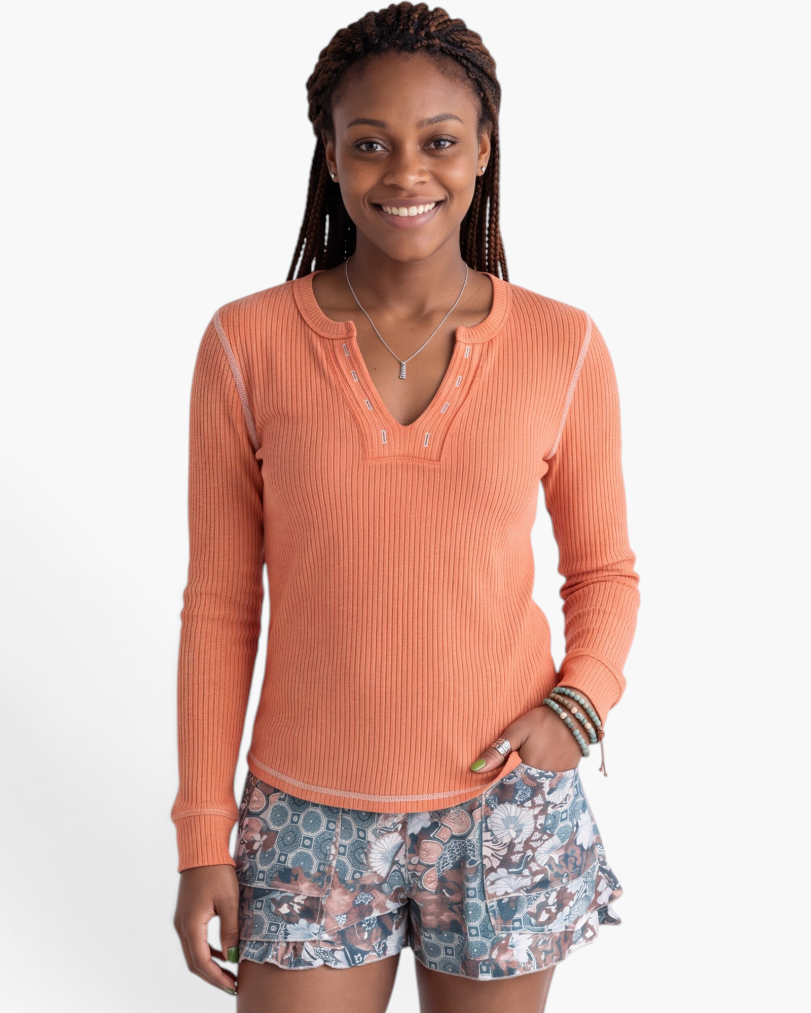 Beach Rose Co. coral ribbed long sleeve V-neck top with contrast stitching and decorative neckline detail.