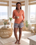 Beach Rose Co. coral ribbed long sleeve V-neck top with contrast seams and decorative stitching.