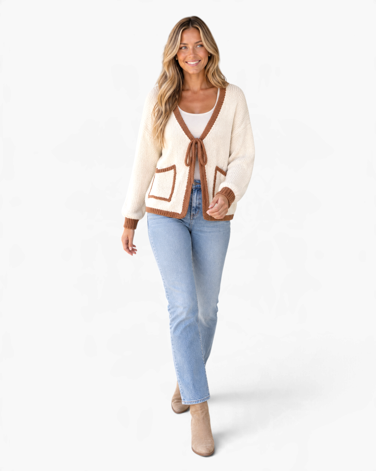 Beach Rose Co. cream knit cardigan with brown trim, tie-front, and patch pockets worn by a smiling woman with jeans.