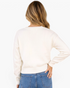 Beach Rose Co. cream crewneck sweater with long sleeves and ribbed hem, shown from the back on a blonde model