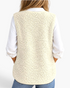 Back view of a woman wearing a Beach Rose Co. cream polar fleece vest over a white shirt and blue jeans.