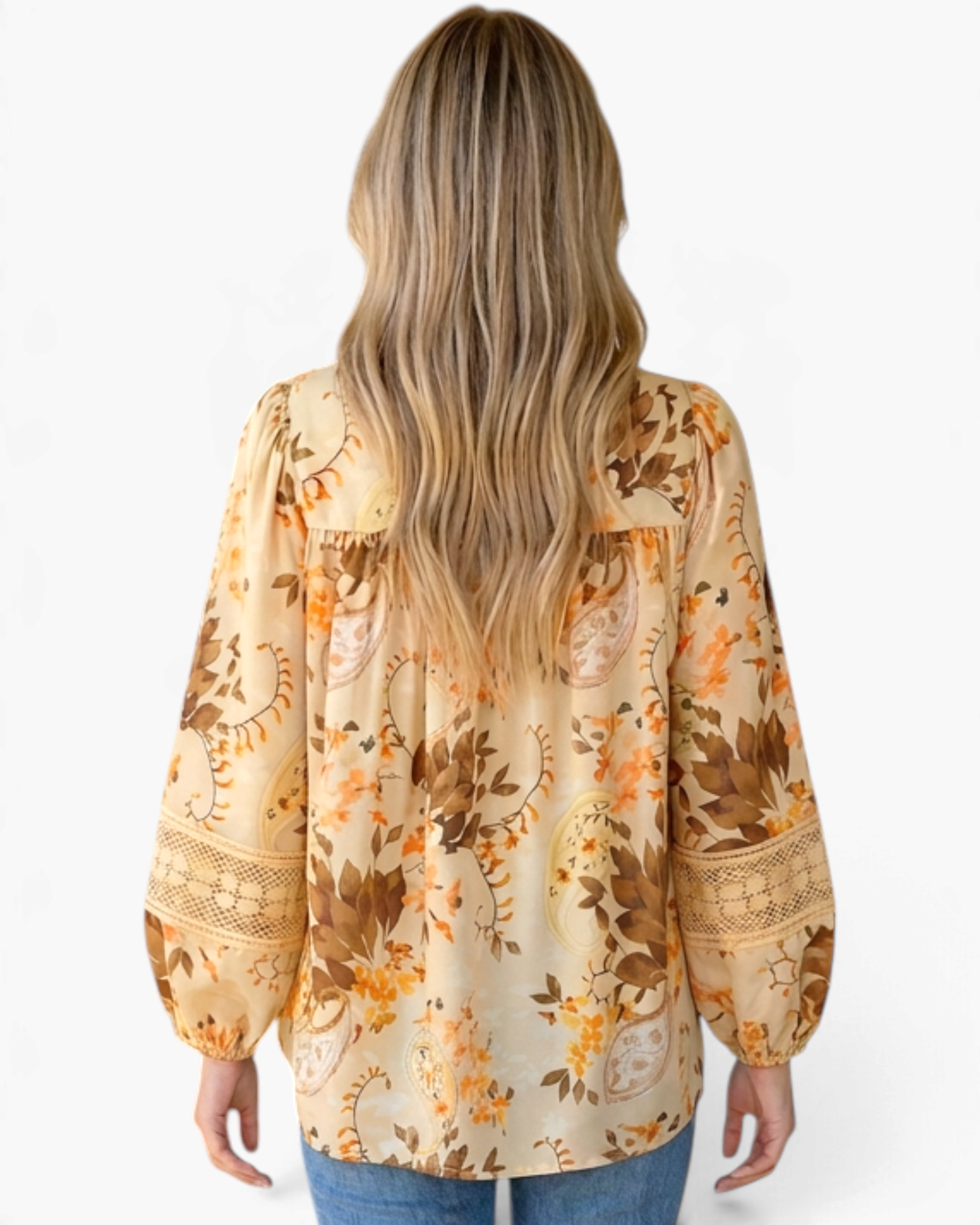 Beach Rose Co. cream blouse with floral and paisley print, long billowy sleeves, and lace inserts, back view.