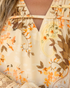 Beach Rose Co. cream blouse featuring a warm floral and paisley print, split V-neckline, and delicate ladder trim.