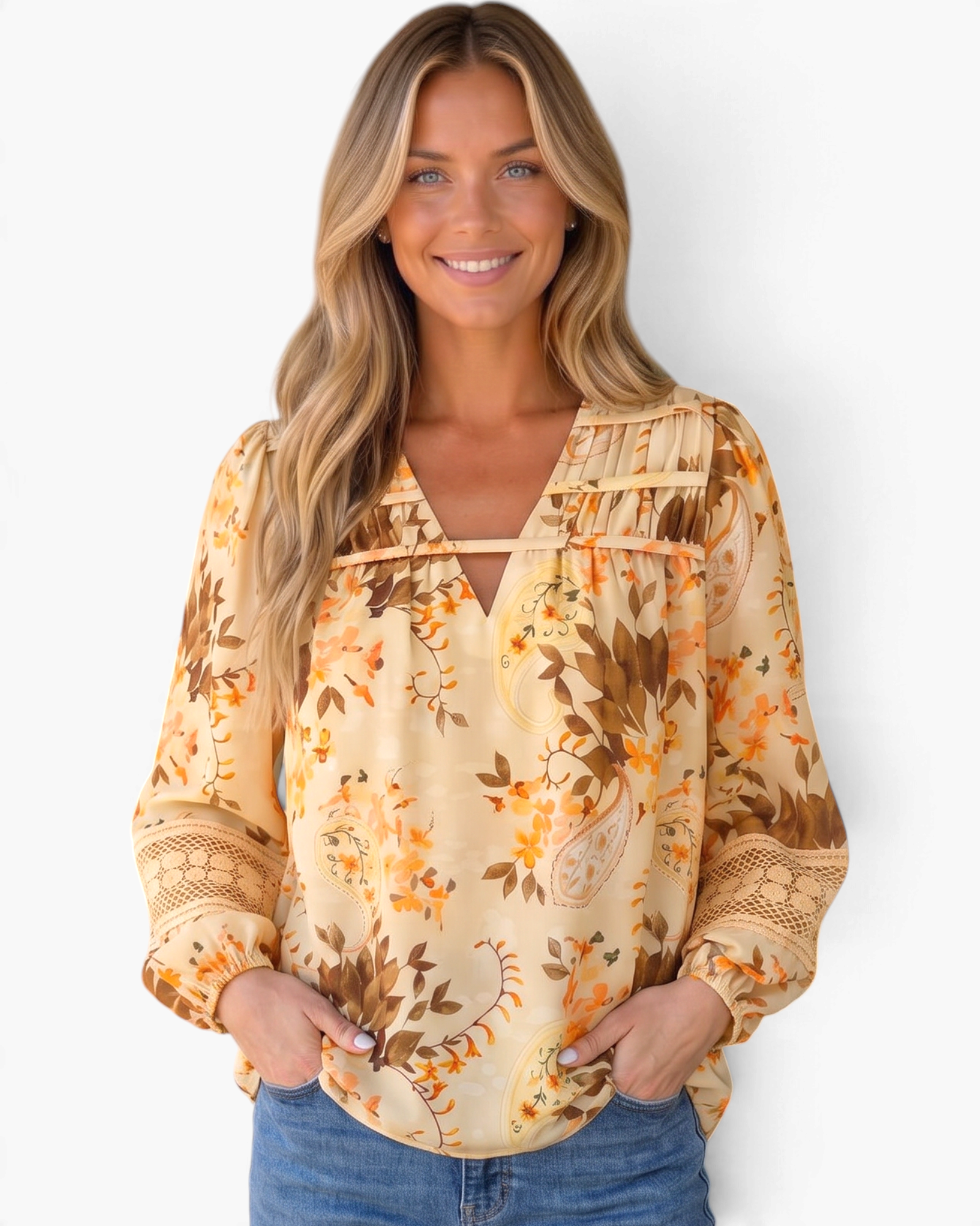 Beach Rose Co. cream floral and paisley blouse with billowy sleeves, lace inserts, and ladder trim on a smiling model.