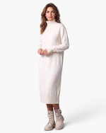Beach Rose Co. cream midi sweater dress with a ribbed turtleneck and long sleeves worn by a woman with ankle boots