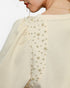 Beach Rose Co. cream knit jacquard top featuring puff sleeves and delicate pearl embellishments on the shoulder