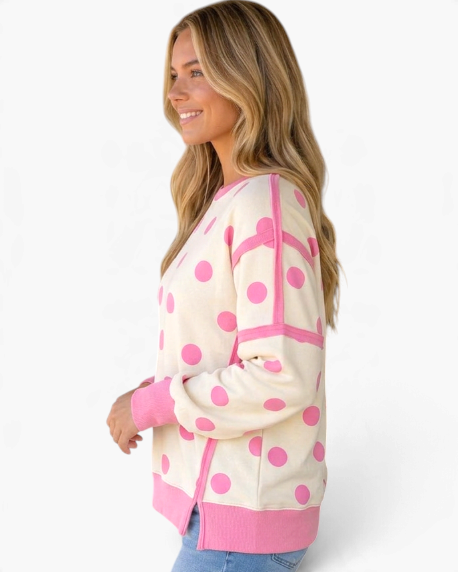 Beach Rose Co. cream sweatshirt with pink polka dots, exposed seams, and ribbed trim worn by a smiling blonde woman.
