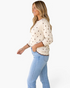 Beach Rose Co. cream cotton sweater with brown polka dots, crew neck, and scalloped trim worn by a smiling model