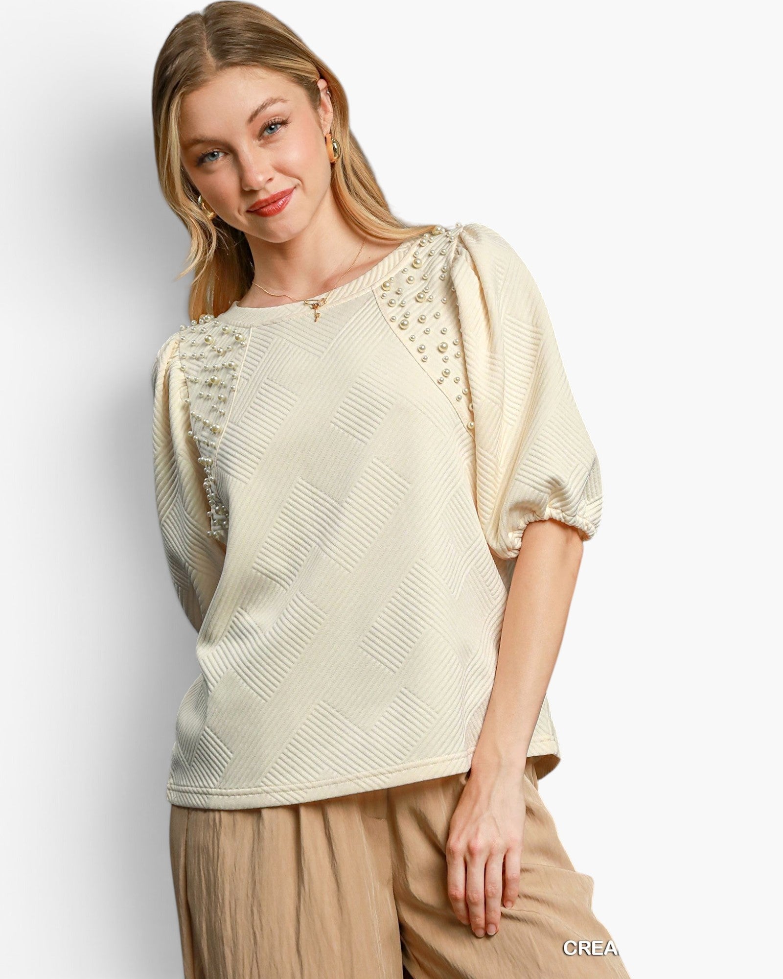 Beach Rose Co. cream knit jacquard top with puff sleeves and pearl embellishments worn by a blonde model